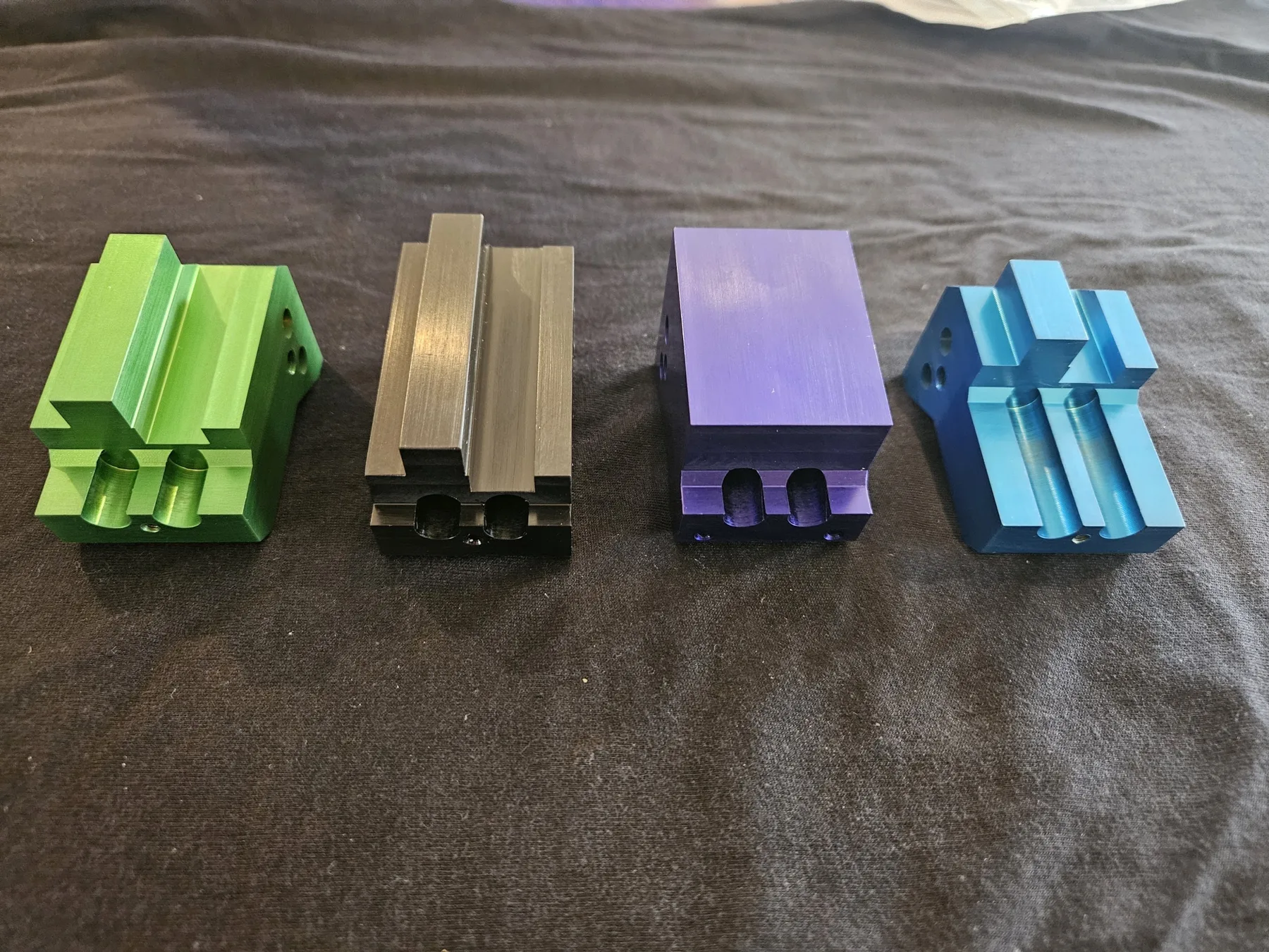 Anodized fixture blocks in green, gray, purple, and blue