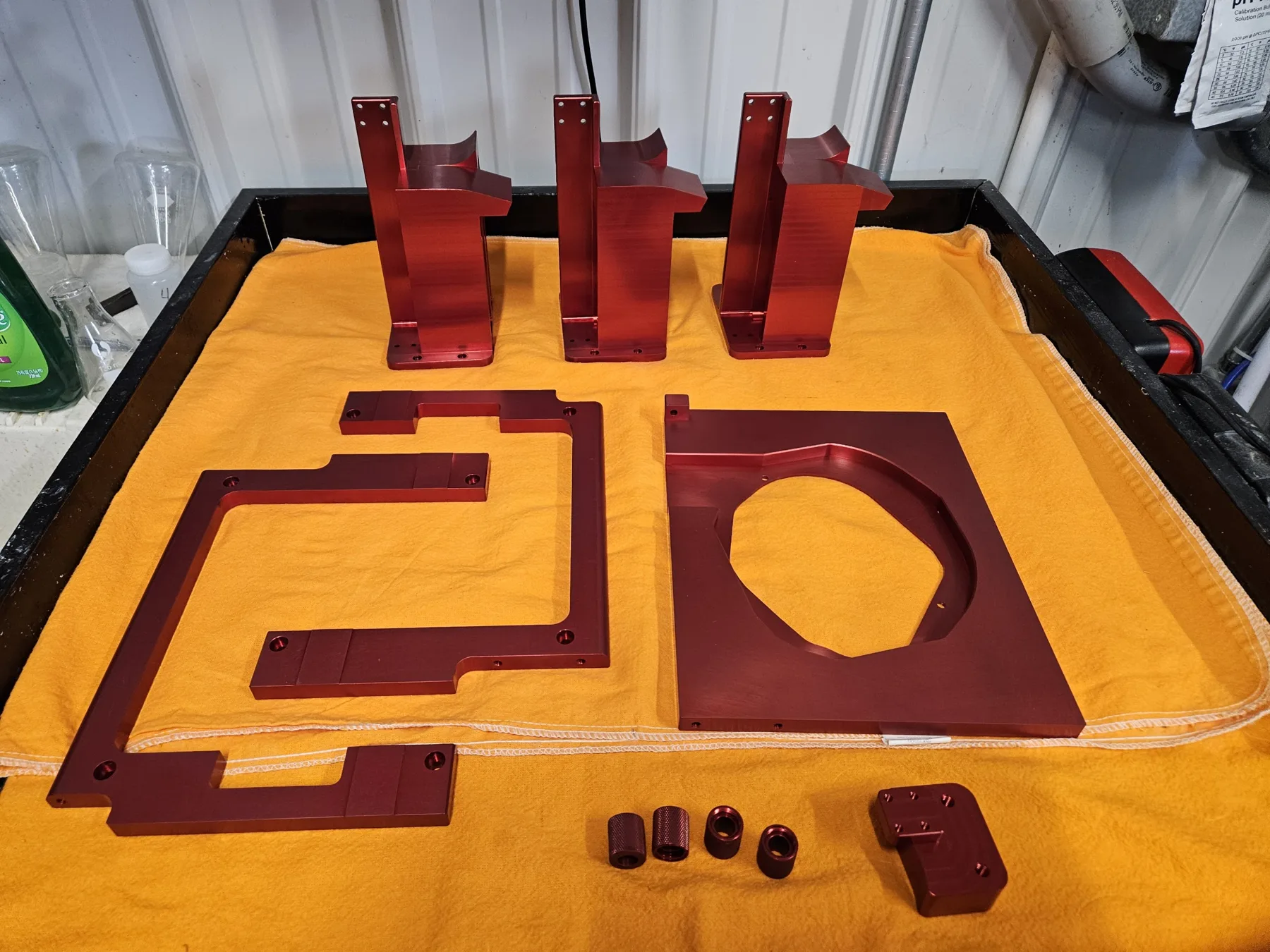 Red anodized brackets and fittings finished at AnoPRO